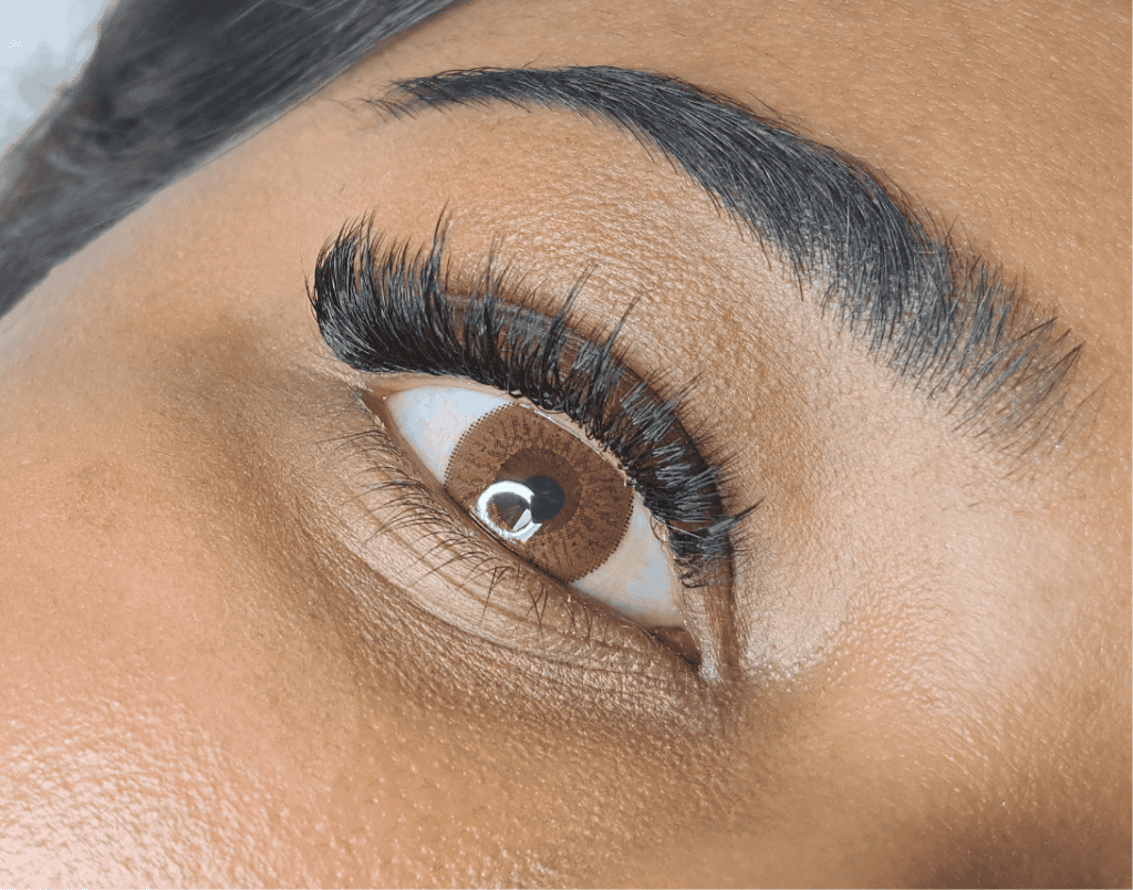 Beautifully enhanced eye with professional lash extensions for a natural, voluminous look. Perfect for adding length and fullness to your lashes.