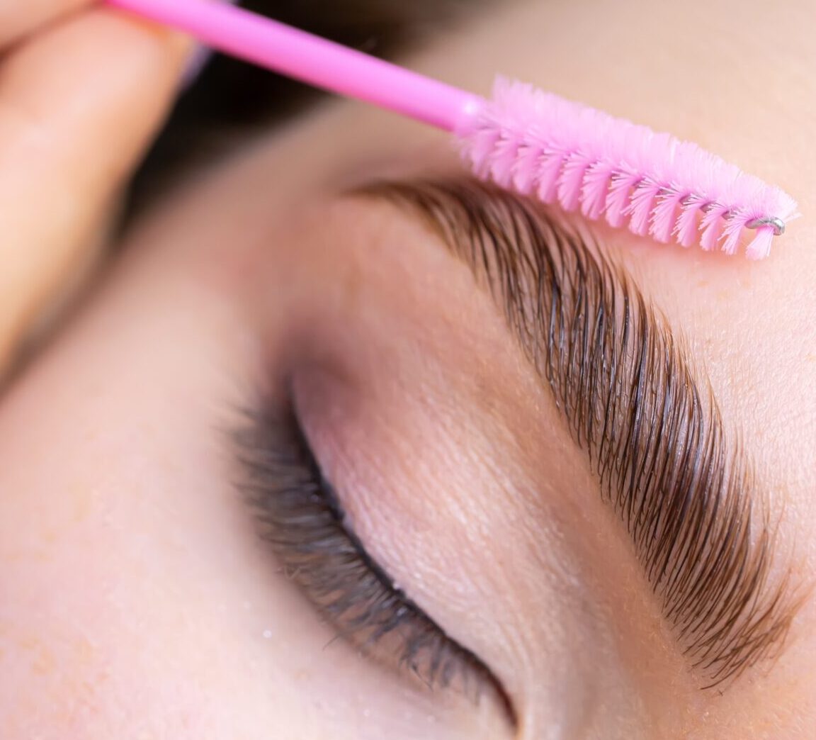 Flawless eyebrows being shaped during a beauty treatment at Belle Ame Skin & Beauty clinic, showcasing professional eyebrow grooming, waxing, and threading services in a calm and clean salon environment.